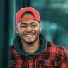 A man wearing a cap on backwards smiles after completing the DOT SAP RTD program